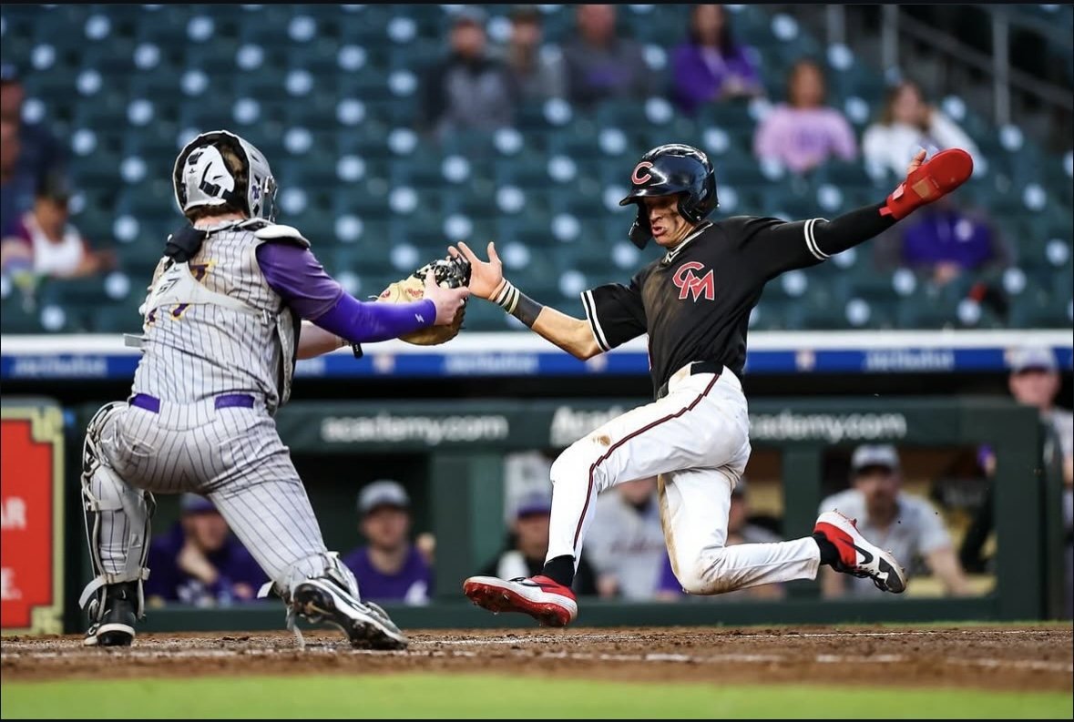 Mules runner in the black jersey sliding home under the tag